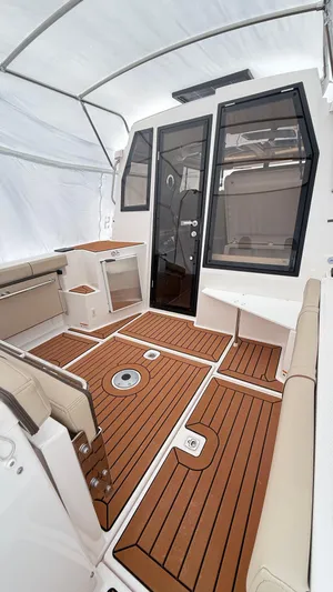  Yacht Photos Pics 2026 Ranger Tugs R-27 boat interior with teak flooring and modern seating.