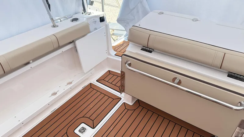  Yacht Photos Pics 2026 Ranger Tugs R-27 boat interior with tan seating and wood-patterned flooring.