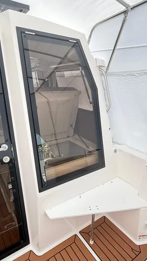  Yacht Photos Pics 2026 Ranger Tugs R-27 boat interior with sleek window and wooden flooring.