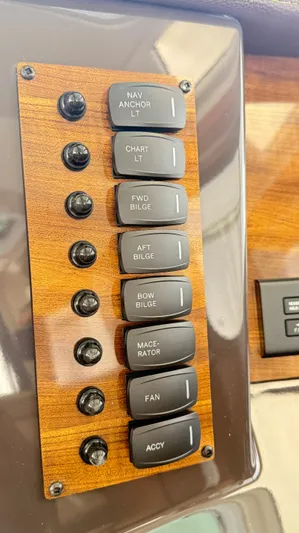  Yacht Photos Pics Control panel of 2026 Ranger Tugs R-27 with labeled switches on wood finish.