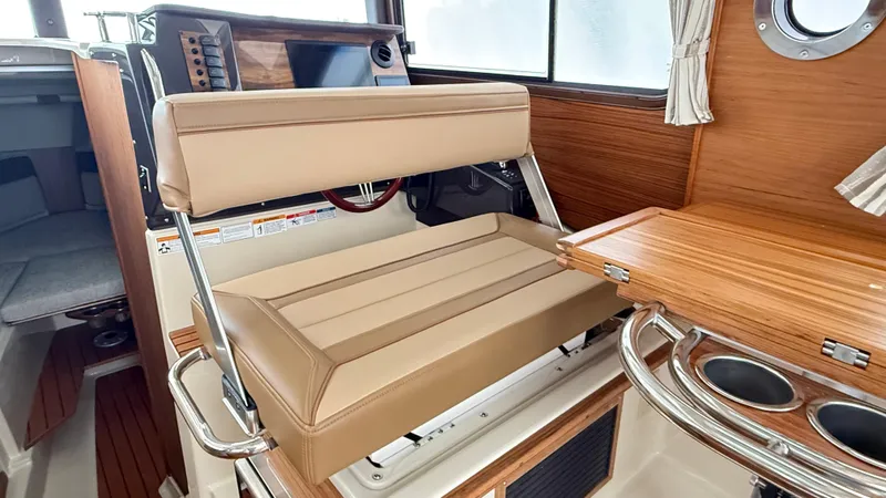  Yacht Photos Pics 2026 Ranger Tugs R-27 interior with beige seating and wooden accents.