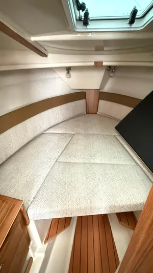  Yacht Photos Pics 2026 Ranger Tugs R-27 cabin interior with cushioned seating and wooden accents.