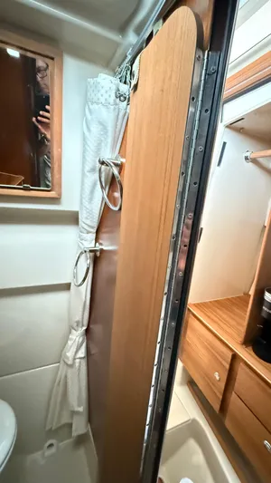  Yacht Photos Pics Bathroom interior of 2026 Ranger Tugs R-27 with wooden door and mirror.