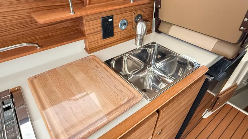  Yacht Photos Pics 2026 Ranger Tugs R-27 galley with wooden countertop and stainless steel sink.