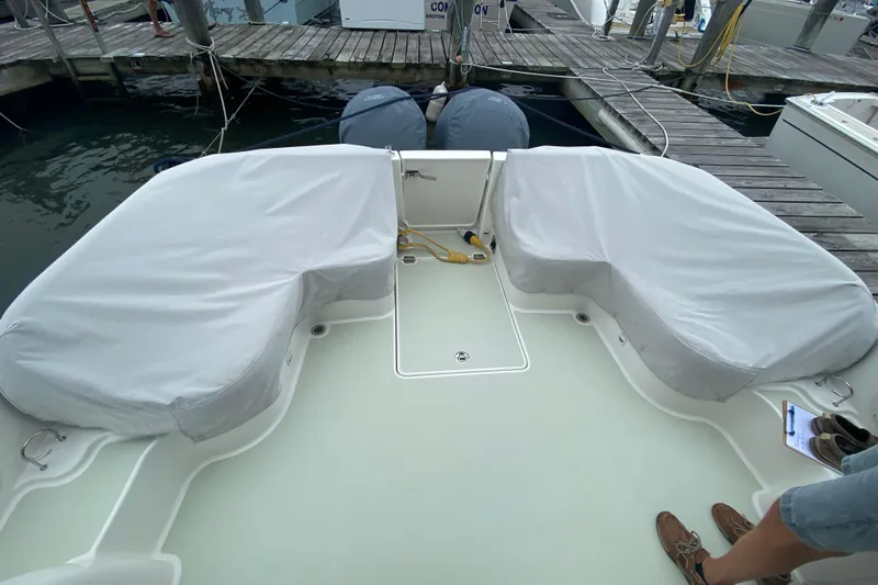 Laure Marie Yacht Photos Pics 2020 Back Cove 34O boat deck with covered seating at a marina.