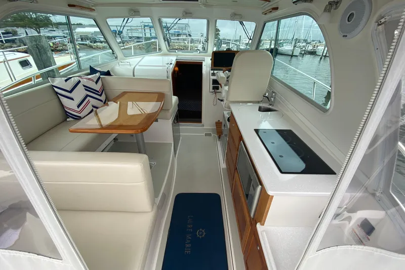 Laure Marie Yacht Photos Pics Interior of 2020 Back Cove 34O yacht with modern kitchen and seating area.