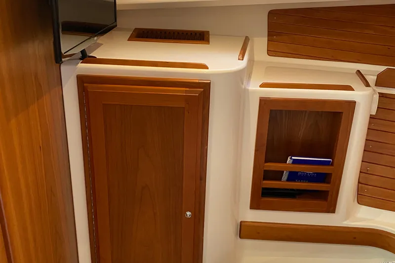 Laure Marie Yacht Photos Pics 2020 Back Cove 34O interior with wooden cabinetry and shelving.