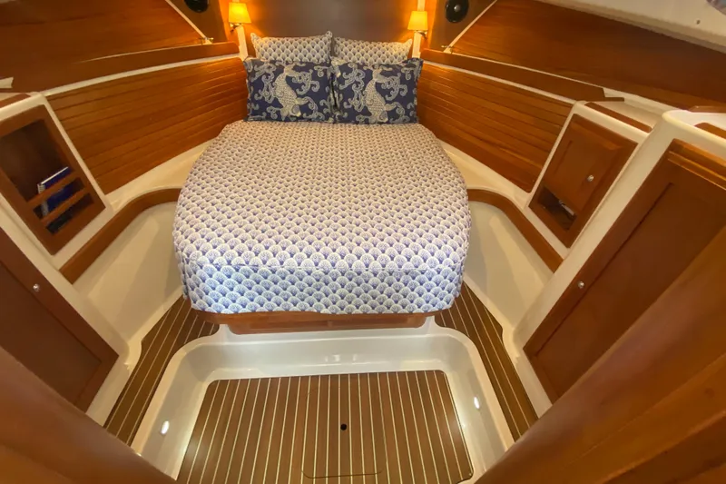 Laure Marie Yacht Photos Pics Luxurious cabin interior of 2020 Back Cove 34O with cozy bed and wooden accents.