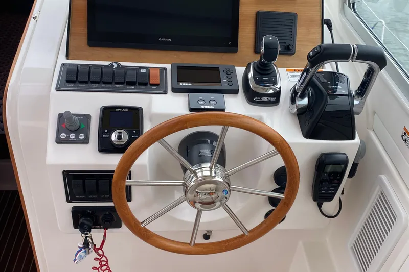 Laure Marie Yacht Photos Pics Helm of 2020 Back Cove 34O boat with steering wheel and control panel.