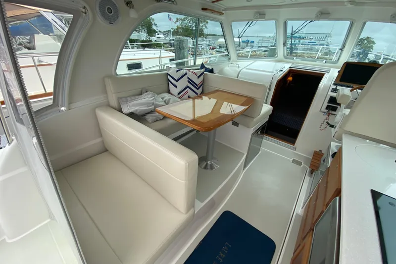 Laure Marie Yacht Photos Pics Interior of 2020 Back Cove 34O yacht with seating and table, showcasing modern design.