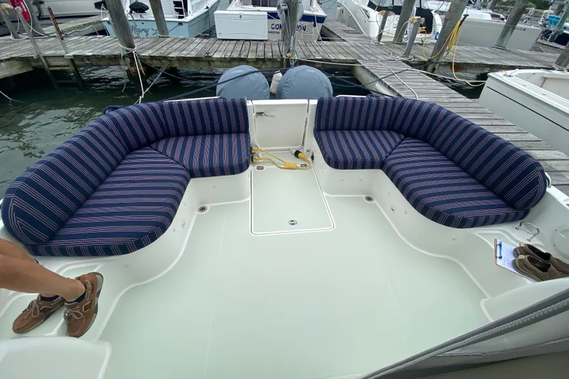 Laure Marie Yacht Photos Pics 2020 Back Cove 34O boat with striped seating at a marina dock.