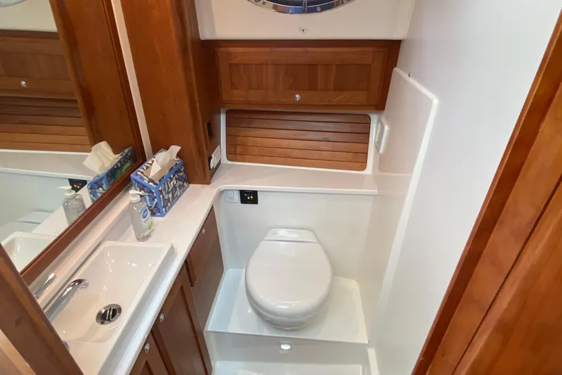 Laure Marie Yacht Photos Pics 2020 Back Cove 34O yacht bathroom with wooden cabinetry and modern fixtures.