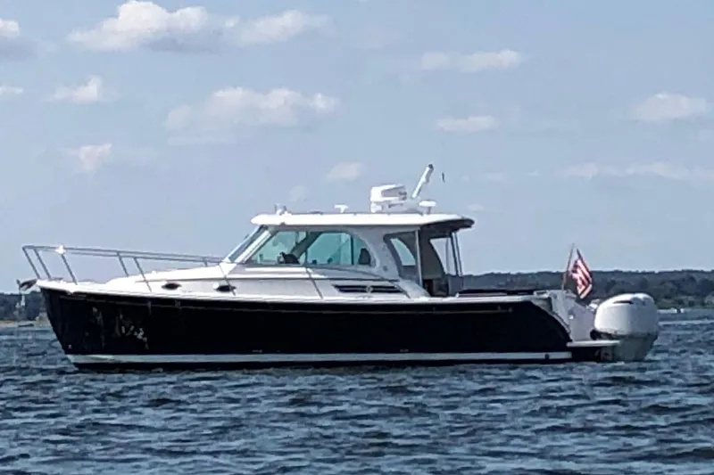 Laure Marie Yacht Photos Pics 2020 Back Cove 34O boat on calm water with American flag.