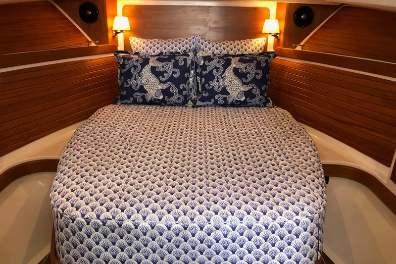 Laure Marie Yacht Photos Pics Cozy cabin interior of 2020 Back Cove 34O with patterned bedding and warm lighting.
