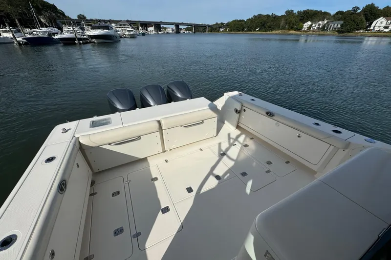  Yacht Photos Pics 2014 Pursuit OS 385 Offshore boat with spacious deck and triple engines on calm water.