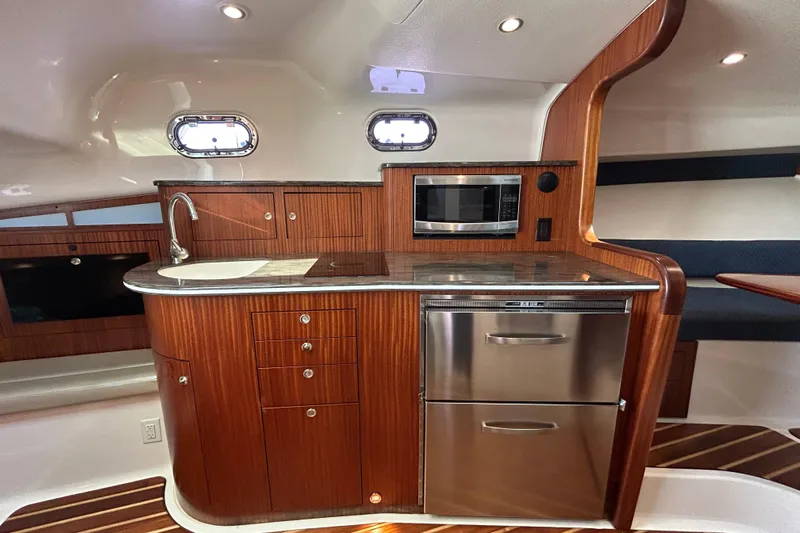  Yacht Photos Pics Luxurious 2014 Pursuit OS 385 Offshore yacht interior with modern kitchen amenities.
