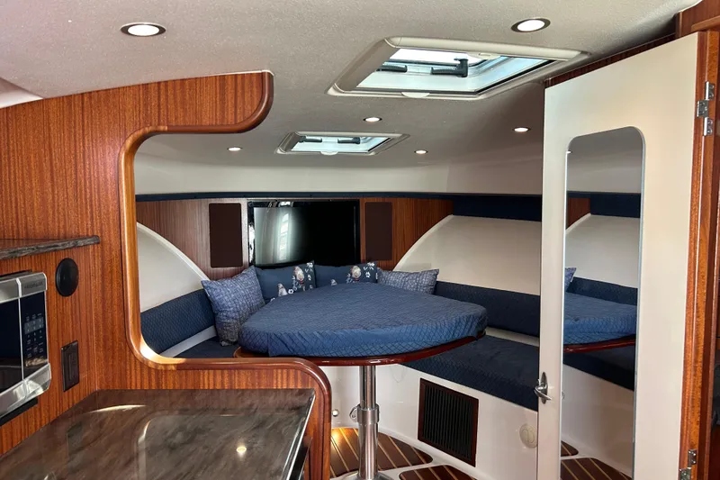  Yacht Photos Pics Luxurious interior of 2014 Pursuit OS 385 Offshore boat with cozy seating and modern amenities.