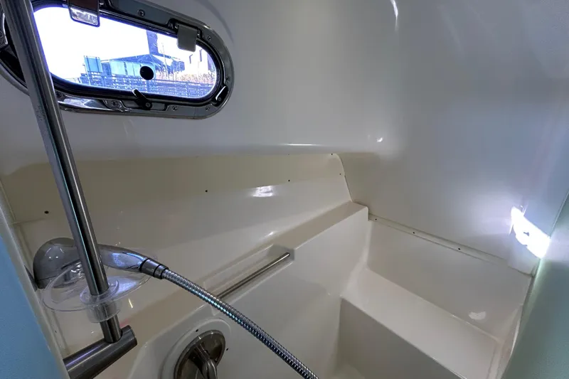 Yacht Photos Pics 2014 Pursuit OS 385 Offshore boat interior shower with window and chrome fixtures.