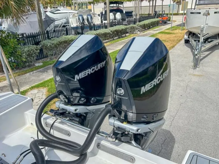  Yacht Photos Pics Dual Mercury outboard motors on AMP Arth 333 boat, 2023 model, docked near other boats.