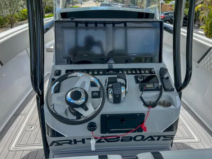  Yacht Photos Pics Control console of AMP Arth 333 boat, featuring dual screens and modern navigation equipment.