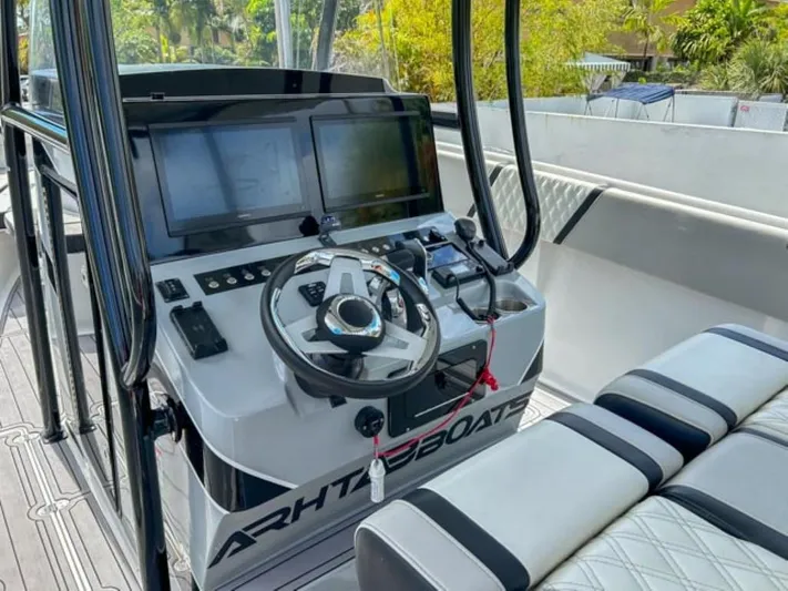  Yacht Photos Pics Control console of AMP Arth 333 boat, 2023 model, featuring dual screens and modern steering.