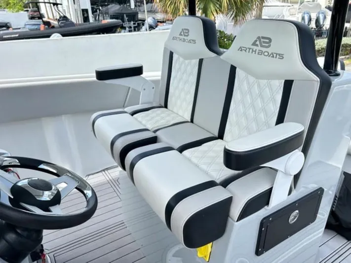  Yacht Photos Pics 2023 AMP Arth 333 boat seats with diamond-stitched upholstery and armrests.