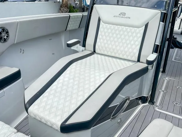  Yacht Photos Pics Luxurious seating on AMP Arth 333 boat, 2023 model, featuring diamond-stitched upholstery.