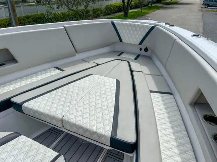  Yacht Photos Pics Luxurious seating area on AMP Arth 333 boat, 2023 model, with diamond-stitched upholstery.