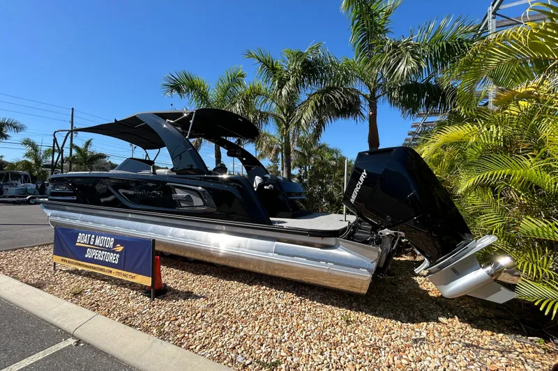  Yacht Photos Pics 2026 Avalon Excalibur 27-foot boat displayed at dealership with palm trees.