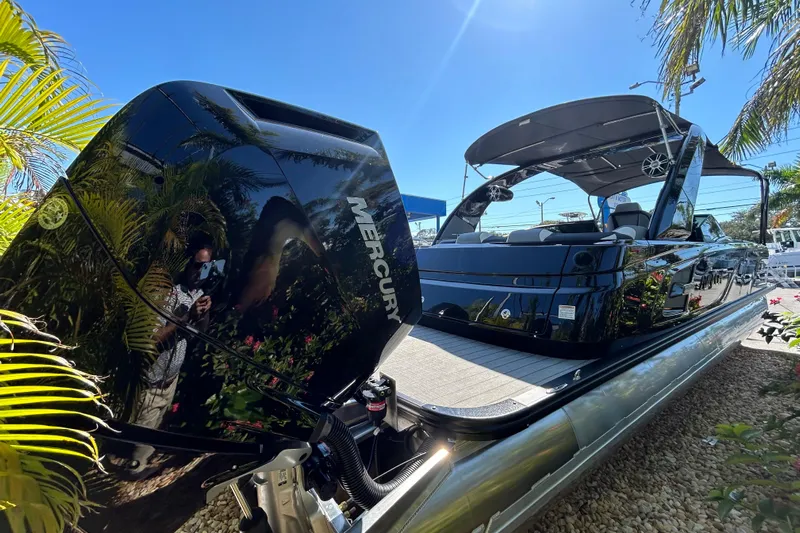  Yacht Photos Pics 2026 Avalon Excalibur 27-Foot boat with Mercury engine, sleek design, and canopy under clear sky.