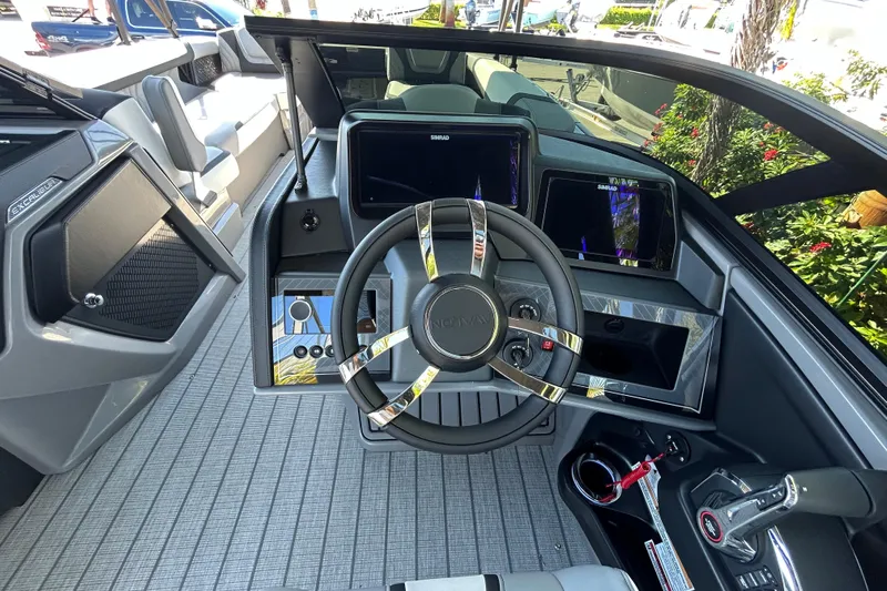  Yacht Photos Pics Interior view of 2026 Avalon Excalibur boat cockpit with modern steering and controls.