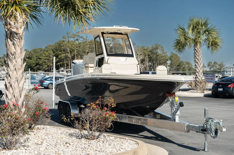  Yacht Photos Pics 2025 Scout 261 XSS boat on trailer, parked near palm trees.