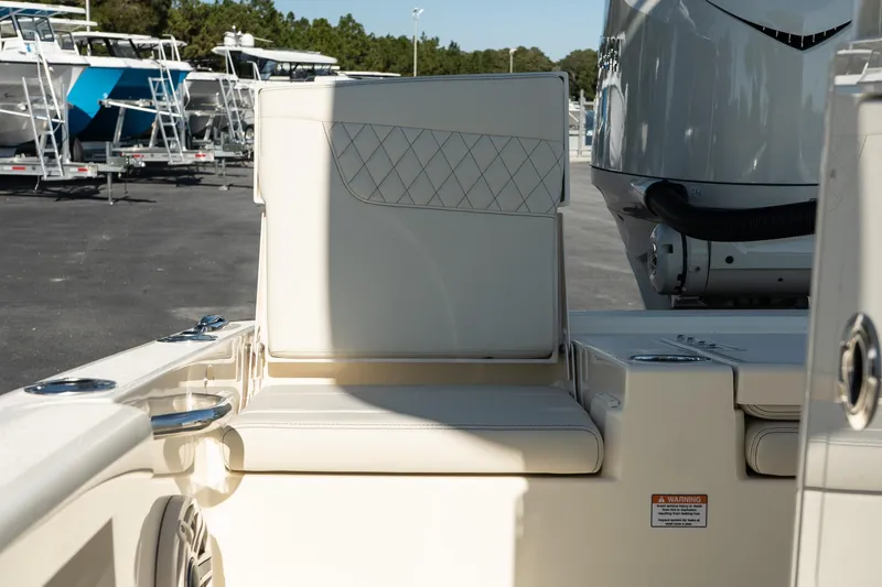  Yacht Photos Pics 2025 Scout 261 XSS boat interior with cushioned seating and motor detail.