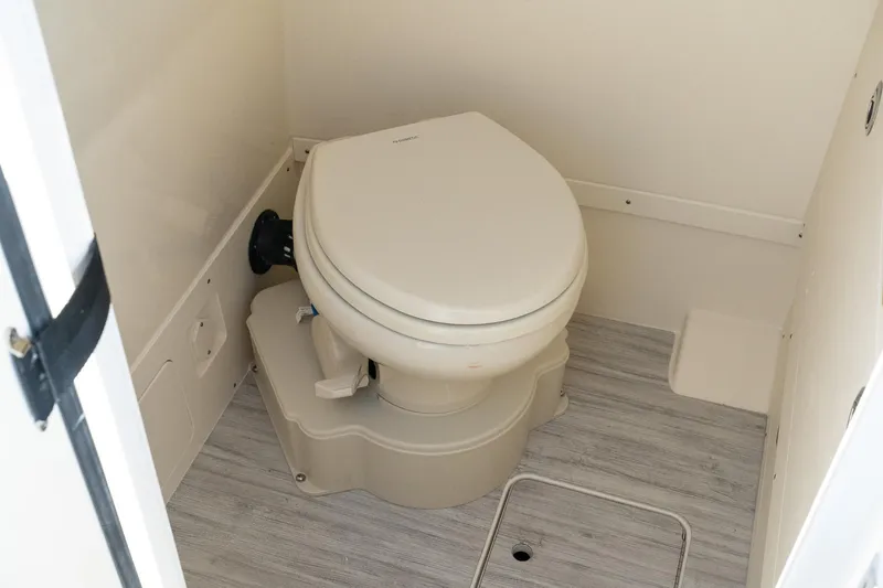  Yacht Photos Pics 2025 Scout 261 XSS boat bathroom with modern toilet and light wood flooring.