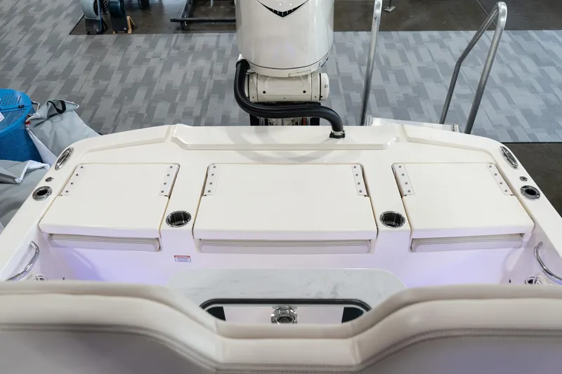  Yacht Photos Pics 2025 Scout 261 XSS boat interior with storage compartments and motor.