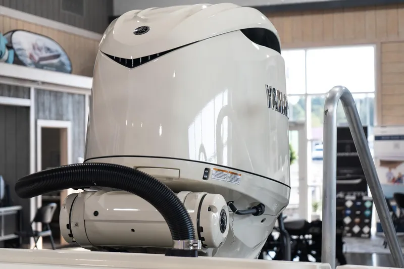  Yacht Photos Pics 2025 Scout 261 XSS boat engine in showroom setting.