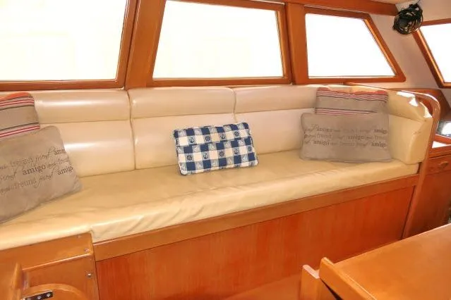 Peregrine Yacht Photos Pics Interior of 2002 Tayana 460 Vancouver Pilothouse with cushioned seating and decorative pillows.