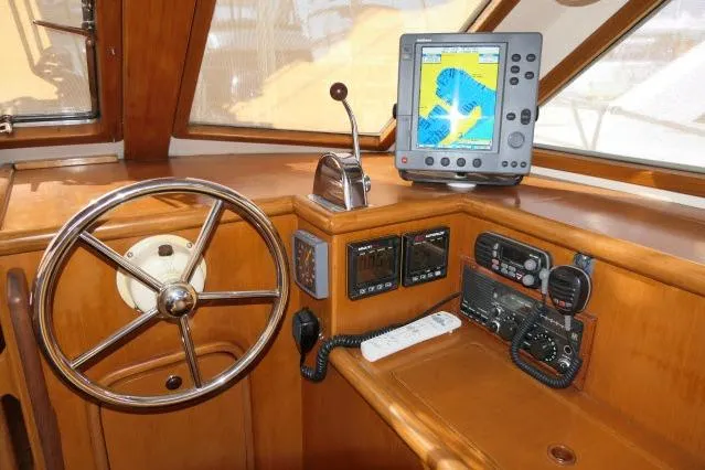 Peregrine Yacht Photos Pics Pilothouse of 2002 Tayana 460 Vancouver with navigation equipment and wooden steering wheel.