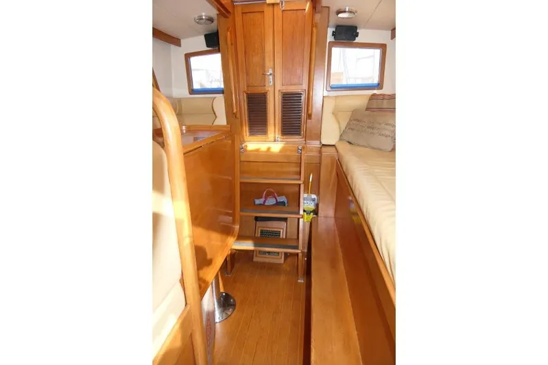 Peregrine Yacht Photos Pics Interior of 2002 Tayana 460 Vancouver Pilothouse with wooden cabinetry and seating.