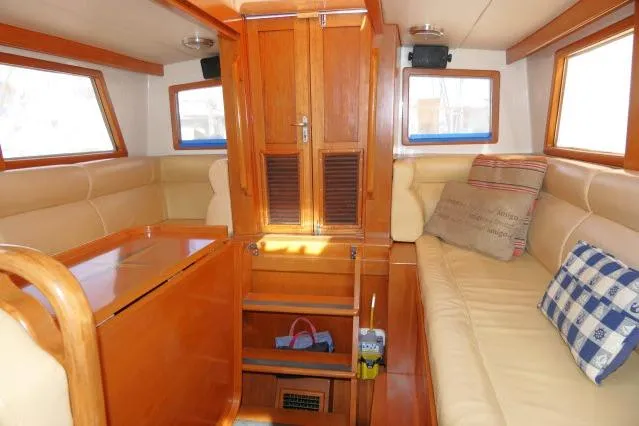 Peregrine Yacht Photos Pics 2002 Tayana 460 Vancouver Pilothouse interior with wooden finishes and beige seating.