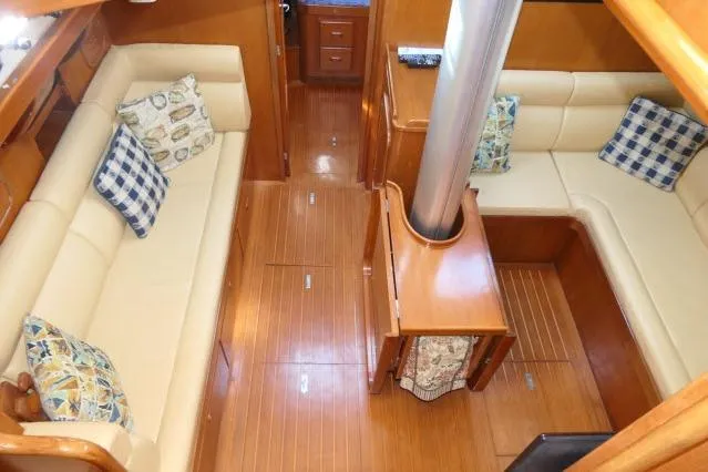 Peregrine Yacht Photos Pics Interior of 2002 Tayana 460 Vancouver Pilothouse with wooden flooring and cushioned seating.