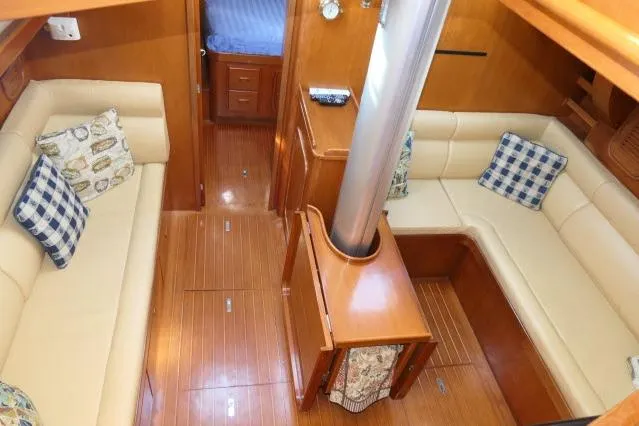 Peregrine Yacht Photos Pics Interior of 2002 Tayana 460 Vancouver Pilothouse with cozy seating and wooden finishes.