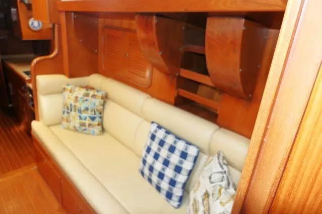 Peregrine Yacht Photos Pics Interior of 2002 Tayana 460 Vancouver Pilothouse with cozy seating and decorative pillows.