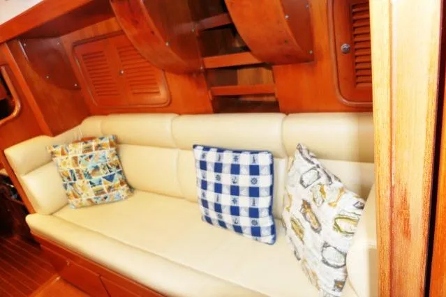 Peregrine Yacht Photos Pics Luxurious interior of 2002 Tayana 460 Vancouver Pilothouse with comfortable seating and decorative pillows.