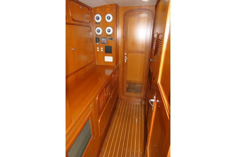 Peregrine Yacht Photos Pics Interior of 2002 Tayana 460 Vancouver Pilothouse with wooden cabinetry and control panels.