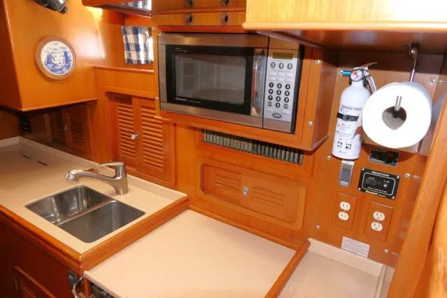 Peregrine Yacht Photos Pics Galley of 2002 Tayana 460 Vancouver Pilothouse with sink, microwave, and storage.