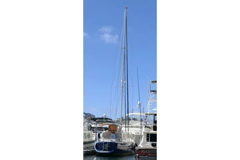 Peregrine Yacht Photos Pics 2002 Tayana 460 Vancouver Pilothouse sailboat docked at marina under clear blue sky.