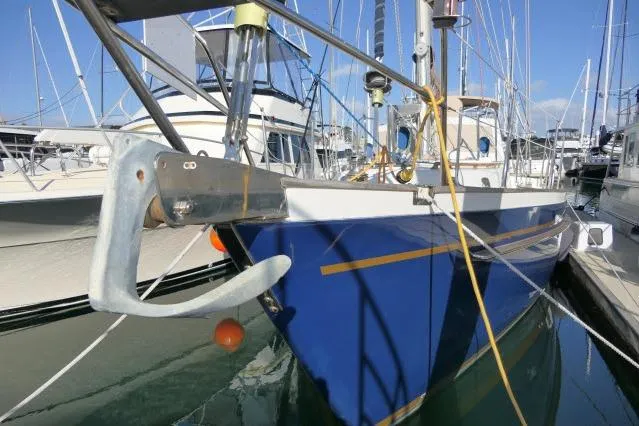 Peregrine Yacht Photos Pics 2002 Tayana 460 Vancouver Pilothouse yacht docked in marina, blue hull, visible anchor.