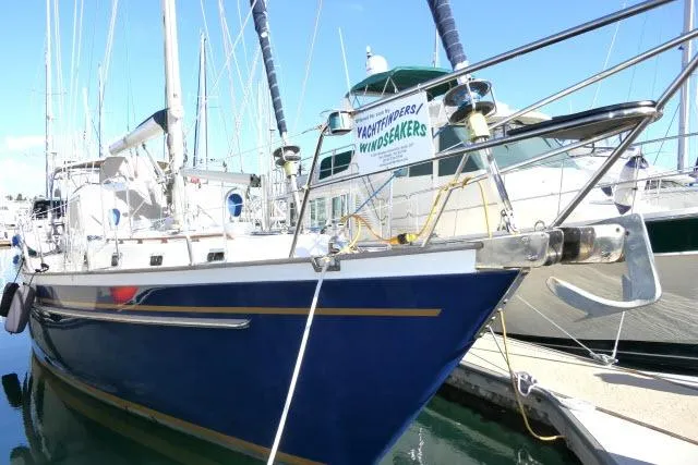 Peregrine Yacht Photos Pics 2002 Tayana 460 Vancouver Pilothouse yacht docked in marina, blue hull, sunny day.