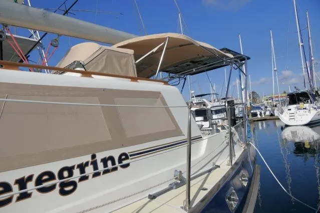 Peregrine Yacht Photos Pics 2002 Tayana 460 Vancouver Pilothouse yacht docked at marina under clear blue sky.